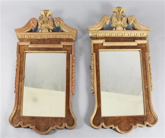 A pair of mid 18th century style carved giltwood and walnut wall mirrors, W.2ft 5in. H.4ft 5in.